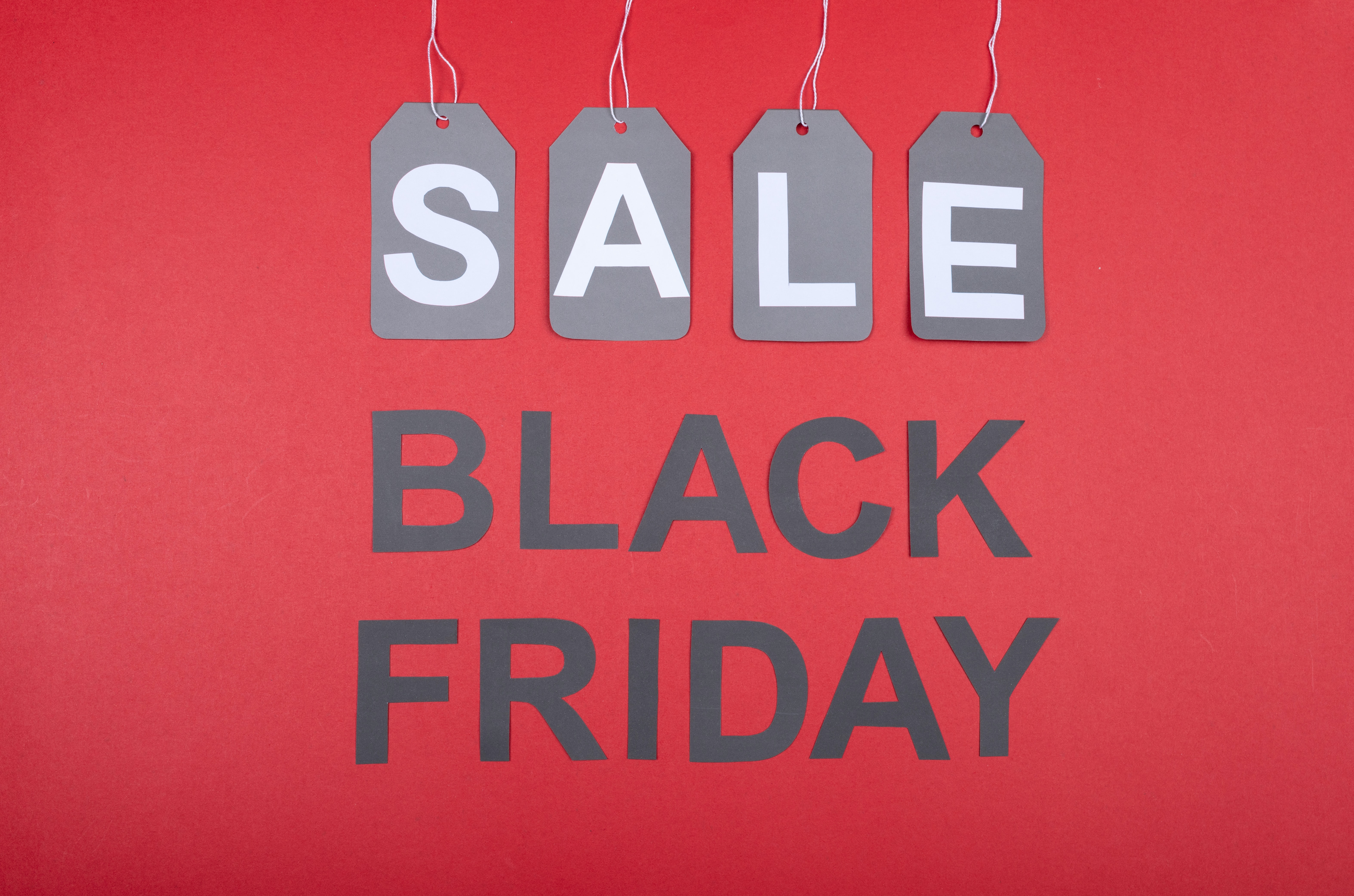 red background with black friday written in black and sale tags